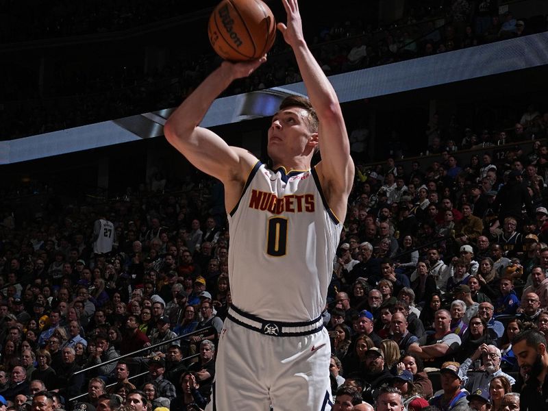 DENVER, CO - FEBRUARY 28: Christian Braun #0 of the Denver Nuggets three point basket during the game against the Sacramento Kings on February 28, 2024 at the Ball Arena in Denver, Colorado. NOTE TO USER: User expressly acknowledges and agrees that, by downloading and/or using this Photograph, user is consenting to the terms and conditions of the Getty Images License Agreement. Mandatory Copyright Notice: Copyright 2024 NBAE (Photo by Garrett Ellwood/NBAE via Getty Images)