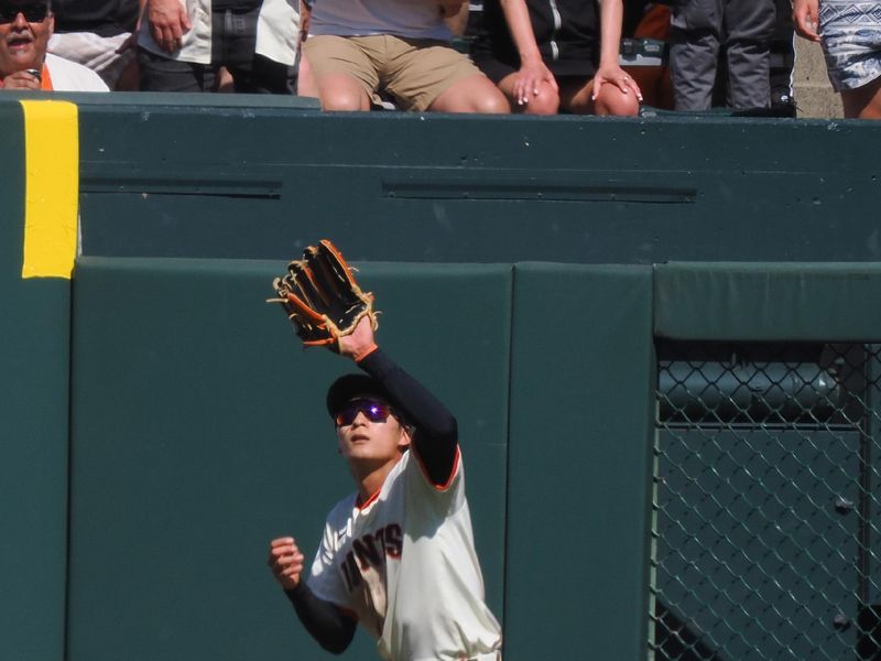 Apr 9, 2025; San Francisco, California, USA;  San Francisco Giants center fielder Jung Hoo Lee (51) catches the ball against the Cincinnati Reds during the tenth inning at Oracle Park. Mandatory Credit: Kelley L Cox-Imagn Images