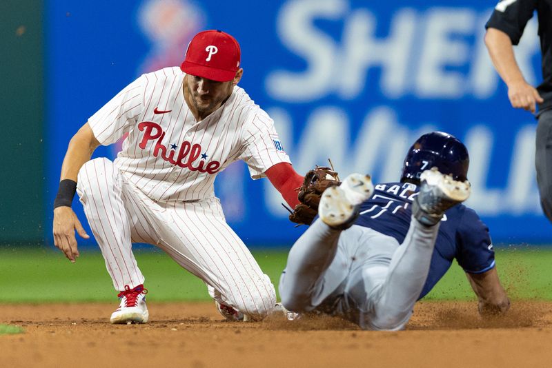 Sep 11, 2024; Philadelphia, Pennsylvania, USA; Philadelphia Phillies shortstop Trea Turner (7) tags out Tampa Bay Rays shortstop Jose Caballero (7) as he attempts to steal second base during the ninth inning at Citizens Bank Park. Mandatory Credit: Bill Streicher-Imagn Images