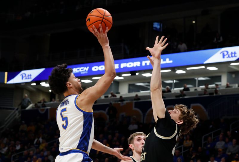 Jan 25, 2023; Pittsburgh, Pennsylvania, USA; Pittsburgh Panthers forward Nate Santos (5) shoots against Wake Forest Demon Deacons forward Zach Keller (25) during the first half at the Petersen Events Center. Mandatory Credit: Charles LeClaire-USA TODAY Sports