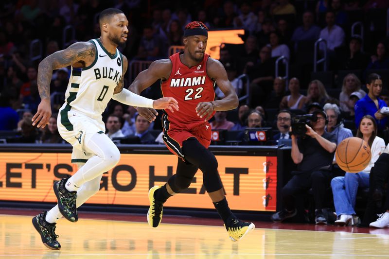 MIAMI, FLORIDA - NOVEMBER 26: Damian Lillard #0 of the Milwaukee Bucks and Jimmy Butler #22 of the Miami Heat chase down the ball during the third quarter of the Emirates NBA Cup at Kaseya Center on November 26, 2024 in Miami, Florida. NOTE TO USER: User expressly acknowledges and agrees that, by downloading and or using this photograph, User is consenting to the terms and conditions of the Getty Images License Agreement. (Photo by Megan Briggs/Getty Images)