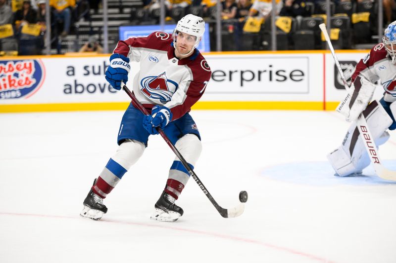 Nov 2, 2024; Nashville, Tennessee, USA;  during the first period at Bridgestone Arena. Mandatory Credit: Steve RoColorado Avalanche defenseman Devon Toews (7) clears the puck against the Nashville Predators berts-Imagn Images