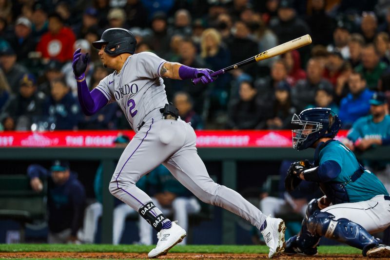 Apr 14, 2023; Seattle, Washington, USA; Colorado Rockies center fielder Yonathan Daza (2) hits an RBI-single against the Seattle Mariners during the sixth inning at T-Mobile Park. Mandatory Credit: Joe Nicholson-USA TODAY Sports