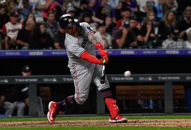 Sep 30, 2023; Denver, Colorado, USA; Minnesota Twins catcher Christian Vazquez (8) singles to right field in the sixth inning against the Colorado Rockies at Coors Field. Mandatory Credit: John Leyba-USA TODAY Sports