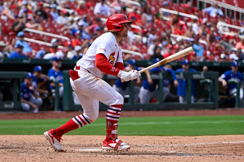 Jul 31, 2024; St. Louis, Missouri, USA;  St. Louis Cardinals second baseman Brendan Donovan (33) hits a one run sacrifice fly against the Texas Rangers during the seventh inning at Busch Stadium. Mandatory Credit: Jeff Curry-USA TODAY Sports