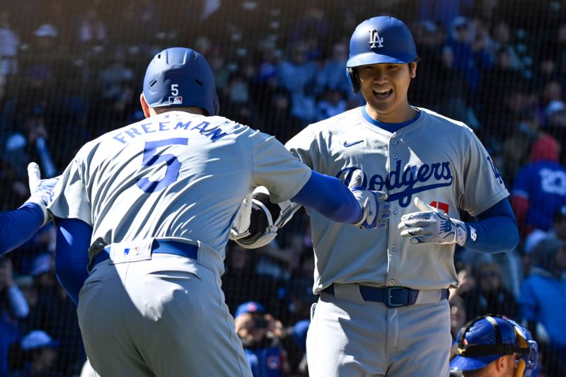 Apr 5, 2024; Chicago, Illinois, USA;  Los Angeles Dodgers two-way player Shohei Ohtani (17) high fives Freddie Freeman (5) after hitting a two-run home run against the Chicago Cubs during the fifth inning at Wrigley Field. Mandatory Credit: Matt Marton-USA TODAY Sports