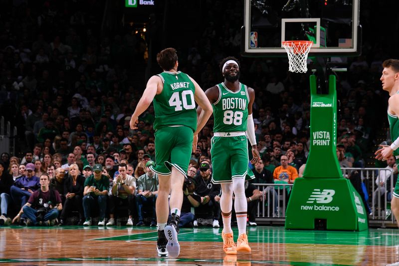 BOSTON, MA - APRIL 12:  Luke Kornet #40 high fives  Neemias Queta #88 of the Boston Celtics during the game against the Charlotte Hornets on April 12, 2024 at the TD Garden in Boston, Massachusetts. NOTE TO USER: User expressly acknowledges and agrees that, by downloading and or using this photograph, User is consenting to the terms and conditions of the Getty Images License Agreement. Mandatory Copyright Notice: Copyright 2024 NBAE  (Photo by Brian Babineau/NBAE via Getty Images)