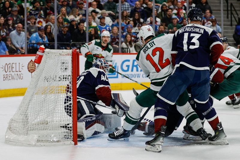 Apr 9, 2024; Denver, Colorado, USA; Minnesota Wild left wing Matt Boldy (12) scores a goal past Colorado Avalanche goaltender Alexandar Georgiev (40) as right wing Valeri Nichushkin (13) defends in the second period at Ball Arena. Mandatory Credit: Isaiah J. Downing-USA TODAY Sports