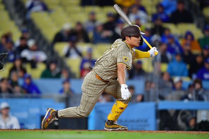 Apr 13, 2024; Los Angeles, California, USA; San Diego Padres shortstop Ha-Seong Kim (7) reaches first on a fielders choice against the Los Angeles Dodgers. during the ninth inning at Dodger Stadium. Mandatory Credit: Gary A. Vasquez-USA TODAY Sports