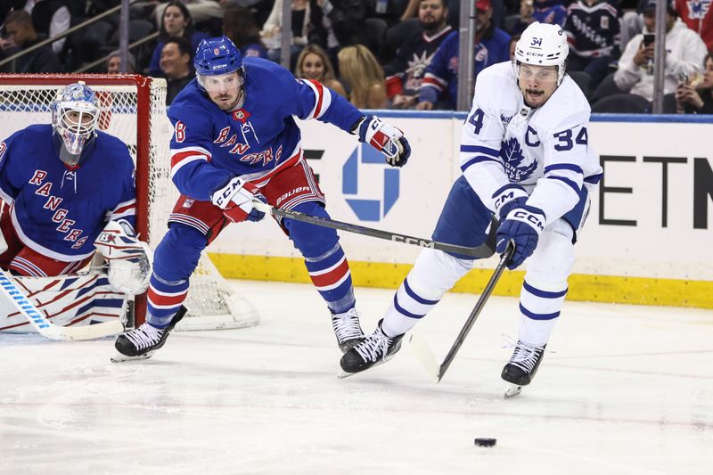 Feb 28, 2025; New York, New York, USA;  New York Rangers left wing J.T. Miller (8) and Toronto Maple Leafs center Auston Matthews (34) chase after the puck in the second period at Madison Square Garden. Mandatory Credit: Wendell Cruz-Imagn Images