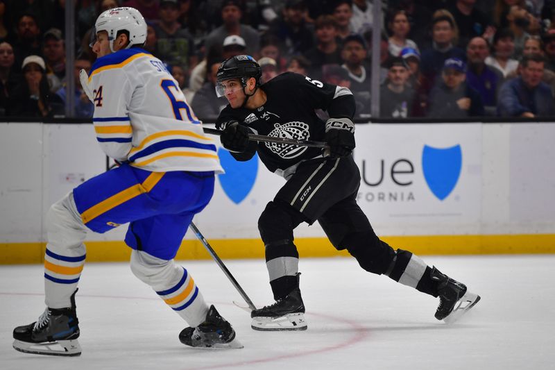 Mar 21, 2026; Los Angeles, California, USA; Los Angeles Kings right wing Jared Wright (53) shoots on goal against the defense of Buffalo Sabres defenseman Logan Stanley (64) during the second period at Crypto.com Arena. Mandatory Credit: Gary A. Vasquez-Imagn Images