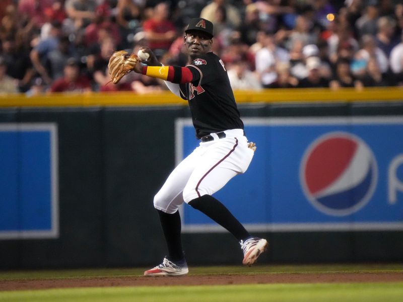 Jun 17, 2023; Phoenix, Arizona, USA; Arizona Diamondbacks infielder Geraldo Perdomo (2) throws to first base after fielding a grounder against the Cleveland Guardians at Chase Field. Mandatory Credit: Joe Rondone-USA TODAY Sports