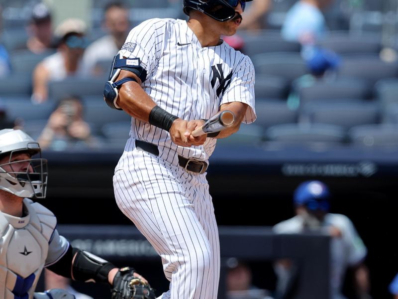 Aug 3, 2024; Bronx, New York, USA; New York Yankees center fielder Trent Grisham (12) follows through on a two run home run against the Toronto Blue Jays during the second inning at Yankee Stadium. Mandatory Credit: Brad Penner-USA TODAY Sports