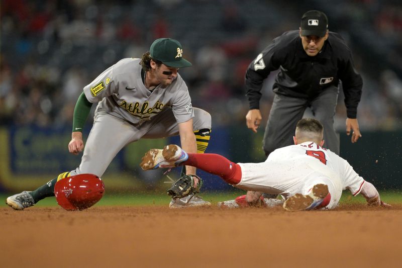 Jun 9, 2025; Anaheim, California, USA;   Los Angeles Angels shortstop Zach Neto (9) bats the tag by Athletics shortstop Jacob Wilson (5) for a stolen base in the eighth inning at Angel Stadium. Mandatory Credit: Jayne Kamin-Oncea-Imagn Images
