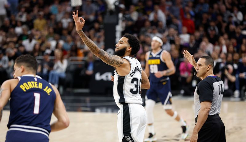 AUSTIN, TX - MARCH 15: Julian Champagne #30 of the San Antonio Spurs reacts after making a three-point shot against the Denver Nuggets in the first half at Moody Center on March 15, 2024 in Austin, Texas. NOTE TO USER: User expressly acknowledges and agrees that, by downloading and or using this photograph, User is consenting to terms and conditions of the Getty Images License Agreement. (Photo by Ronald Cortes/Getty Images)