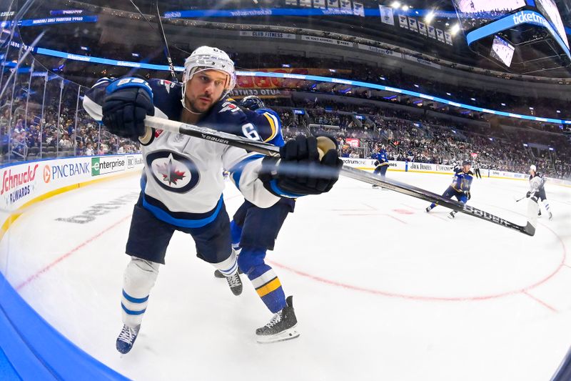 Nov 7, 2023; St. Louis, Missouri, USA;  Winnipeg Jets right wing Nino Niederreiter (62) is checked by St. Louis Blues defenseman Marco Scandella (6) during the third period at Enterprise Center. Mandatory Credit: Jeff Curry-USA TODAY Sports