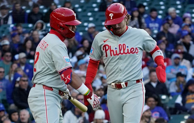 Apr 27, 2025; Chicago, Illinois, USA; Philadelphia Phillies second base Bryson Stott (right) is greeted by Philadelphia Phillies designated hitter Kyle Schwarber (12) after scoring against the Chicago Cubs during the third inning at Wrigley Field. Mandatory Credit: David Banks-Imagn Images