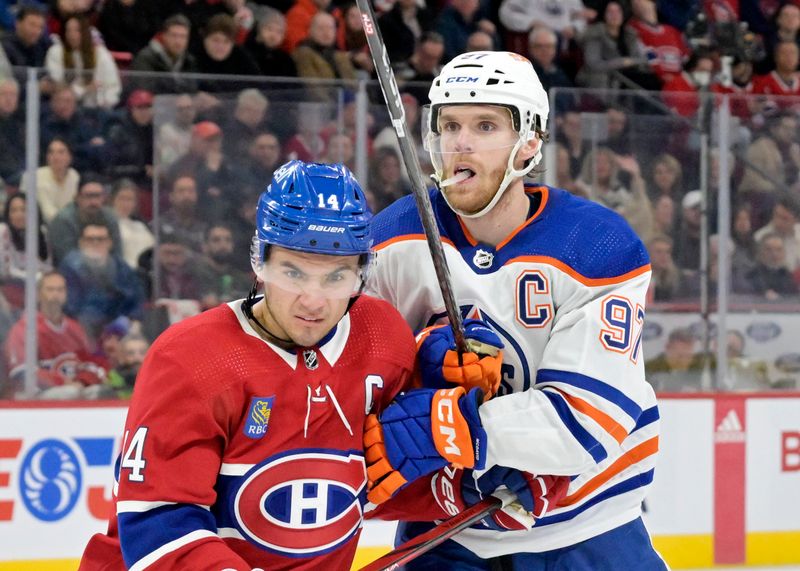 Jan 13, 2024; Montreal, Quebec, CAN; Montreal Canadiens forward Nick Suzuki (14) and Edmonton Oilers forward Connor McDavid (97) during the third period at the Bell Centre. Mandatory Credit: Eric Bolte-USA TODAY Sports