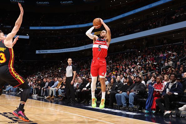 WASHINGTON, DC -? DECEMBER 31: Tyus Jones #5 of the Washington Wizards shoots a three point basket during the game against the Atlanta Hawks on December 31, 2023 at Capital One Arena in Washington, DC. NOTE TO USER: User expressly acknowledges and agrees that, by downloading and or using this Photograph, user is consenting to the terms and conditions of the Getty Images License Agreement. Mandatory Copyright Notice: Copyright 2023 NBAE (Photo by Stephen Gosling/NBAE via Getty Images)