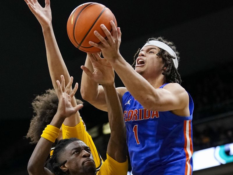 Jan 20, 2024; Columbia, Missouri, USA; Florida Gators guard Walter Clayton Jr. (1) shoots against Missouri Tigers guard Sean East II (55) and forward Noah Carter (35) during the second half at Mizzou Arena. Mandatory Credit: Jay Biggerstaff-USA TODAY Sports