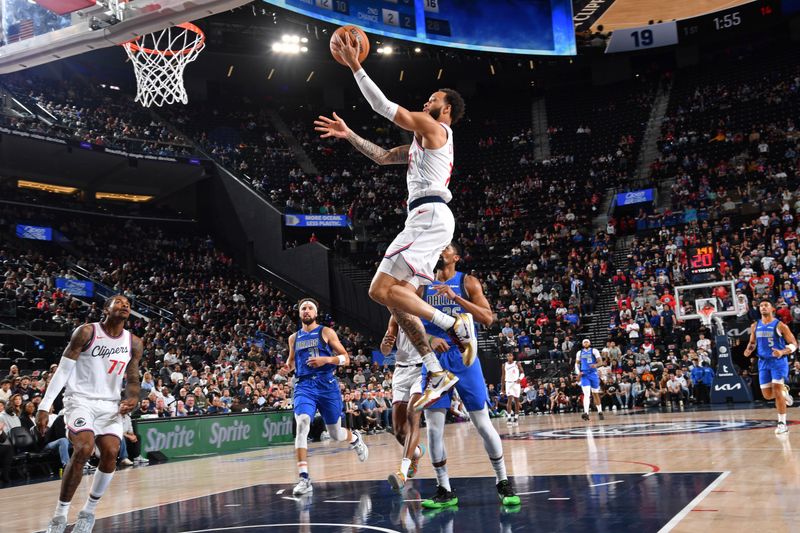 INGLEWOOD, CA - OCTOBER 14: Amir Coffey #7 of the LA Clippers drives to the basket during the game against the Dallas Mavericks on October 14, 2024 at Intuit Dome in Los Angeles, California. NOTE TO USER: User expressly acknowledges and agrees that, by downloading and/or using this Photograph, user is consenting to the terms and conditions of the Getty Images License Agreement. Mandatory Copyright Notice: Copyright 2024 NBAE (Photo by Juan Ocampo/NBAE via Getty Images)