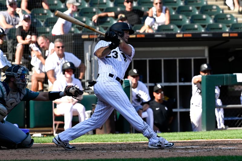 Aug 23, 2023; Chicago, Illinois, USA;  Chicago White Sox left fielder Andrew Benintendi (23) hits an RBI single against the Seattle Mariners during the ninth inning at Guaranteed Rate Field. Mandatory Credit: Matt Marton-USA TODAY Sports