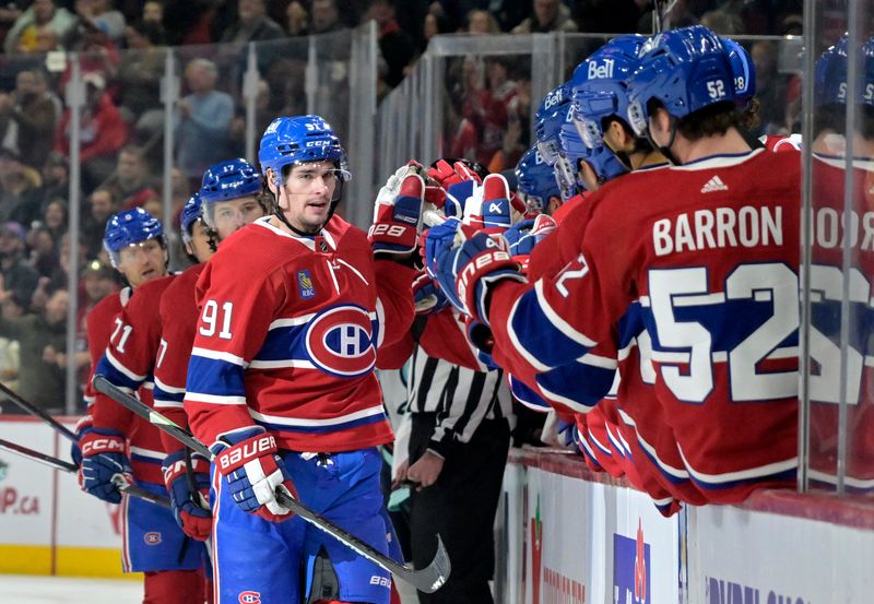 Dec 4, 2023; Montreal, Quebec, CAN; Montreal Canadiens forward Sean Monahan (91) celebrates with teammates after scoring a goal against the Seattle Kraken during the first period at the Bell Centre. Mandatory Credit: Eric Bolte-USA TODAY Sports