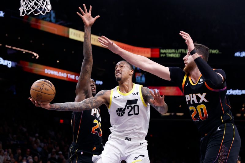 PHOENIX, ARIZONA - FEBRUARY 08: John Collins #20 of the Utah Jazz attempts a layup against Jusuf Nurkic #20 of the Phoenix Suns and Nassir Little #25 during the second half at Footprint Center on February 08, 2024 in Phoenix, Arizona. NOTE TO USER: User expressly acknowledges and agrees that, by downloading and or using this photograph, User is consenting to the terms and conditions of the Getty Images License Agreement.  (Photo by Chris Coduto/Getty Images)