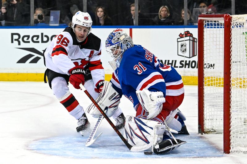 Dec 2, 2024; New York, New York, USA;  New York Rangers goaltender Igor Shesterkin (31) makes a save on New Jersey Devils center Jack Hughes (86) during the first period at Madison Square Garden. Mandatory Credit: Dennis Schneidler-Imagn Images