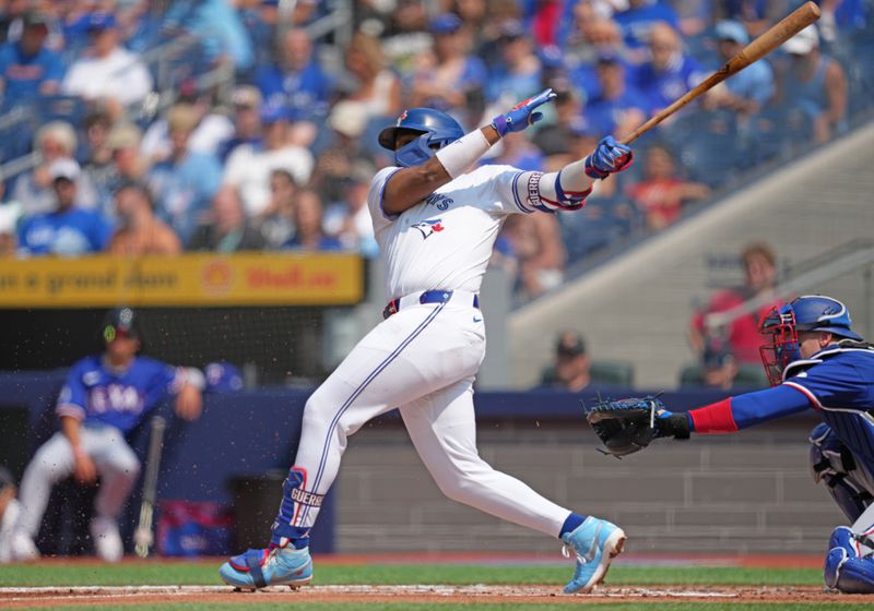 Jul 27, 2024; Toronto, Ontario, CAN; Toronto Blue Jays third baseman Vladimir Guerrero Jr. (27) hits a single against the Texas Rangers during the first inning at Rogers Centre. Mandatory Credit: Nick Turchiaro-USA TODAY Sports