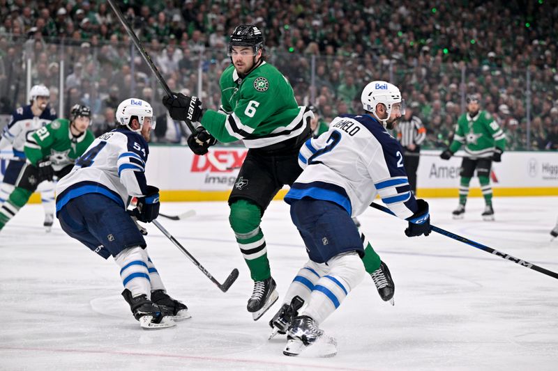 May 13, 2025; Dallas, Texas, USA; Dallas Stars defenseman Lian Bichsel (6) skates between Winnipeg Jets defenseman Dylan Samberg (54) and defenseman Dylan DeMelo (2) during the second period in game four of the second round of the 2025 Stanley Cup Playoffs at American Airlines Center. Mandatory Credit: Jerome Miron-Imagn Images