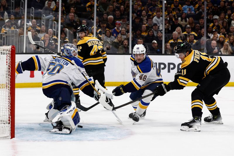 Nov 16, 2024; Boston, Massachusetts, USA; Boston Bruins center Trent Frederic (11) fires a shot past St. Louis Blues goaltender Jordan Binnington (50) for a goal during the first period at TD Garden. Mandatory Credit: Winslow Townson-Imagn Images