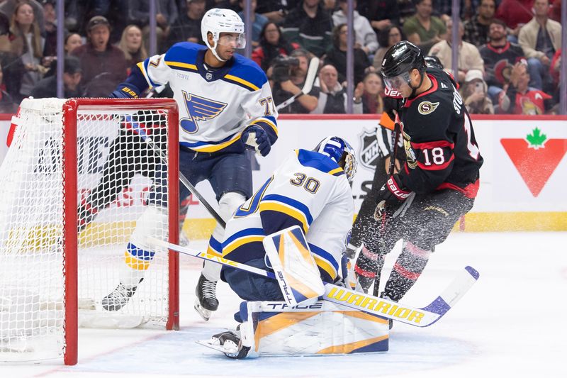 Oct 29, 2024; Ottawa, Ontario, CAN; St. Louis Blues goalie Jordan Binnington (30) makes a save on a shot from  Ottawa Senators center Tim Stutzle (18) in the first period at the Canadian Tire Centre. Mandatory Credit: Marc DesRosiers-Imagn Images