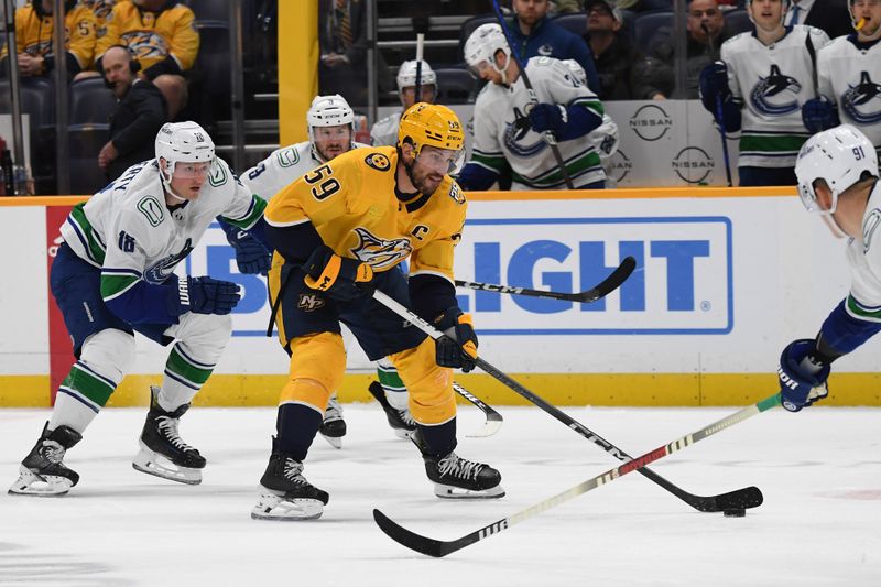 Dec 19, 2023; Nashville, Tennessee, USA; Nashville Predators defenseman Roman Josi (59) skates the puck into the offensive zone during the third period against the Vancouver Canucks at Bridgestone Arena. Mandatory Credit: Christopher Hanewinckel-USA TODAY Sports