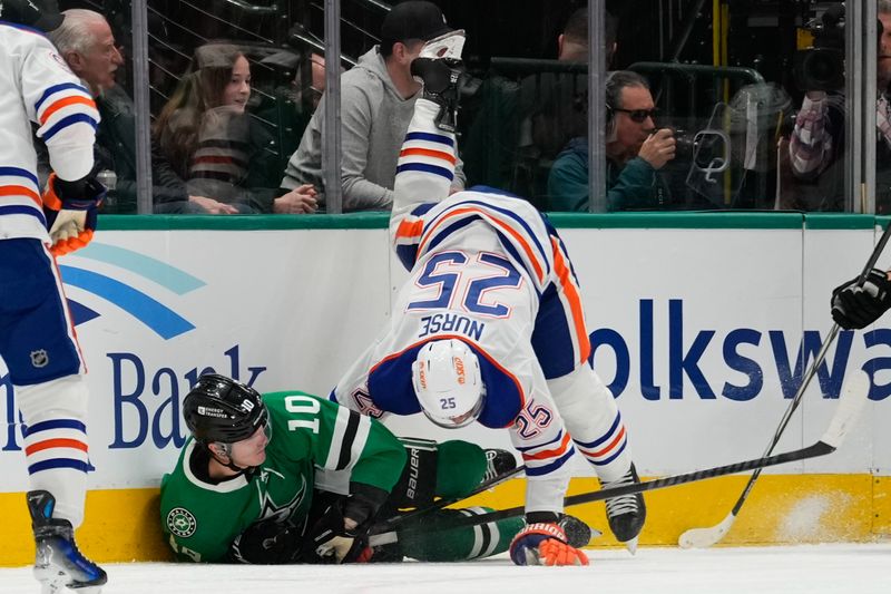 Feb 17, 2024; Dallas, Texas, USA;  Edmonton Oilers defenseman Darnell Nurse (25) is checked by Dallas Stars center Ty Dellandrea (10) during the first period at American Airlines Center. Mandatory Credit: Chris Jones-USA TODAY Sports