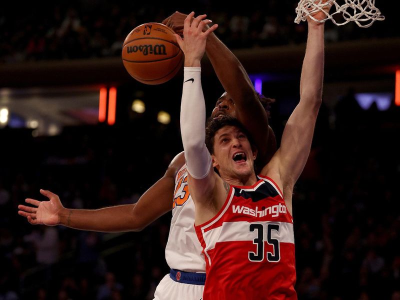 NEW YORK, NEW YORK - OCTOBER 18: Mitchell Robinson #23 of the New York Knicks and Mike Muscala #35 of the Washington Wizards fight for the rebound during a preseason game at Madison Square Garden on October 18, 2023 in New York City. NOTE TO USER: User expressly acknowledges and agrees that, by downloading and or using this photograph, User is consenting to the terms and conditions of the Getty Images License Agreement. (Photo by Elsa/Getty Images)