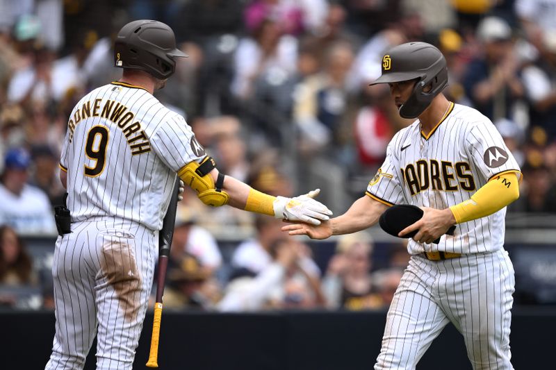 May 17, 2023; San Diego, California, USA; San Diego Padres third baseman Ha-seong Kim (right) is congratulated by first baseman Jake Cronenworth (9) after scoring a run during the sixth inning against the Kansas City Royals at Petco Park. Mandatory Credit: Orlando Ramirez-USA TODAY Sports