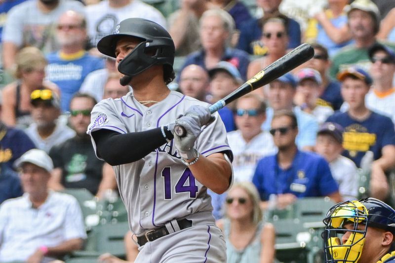 Aug 9, 2023; Milwaukee, Wisconsin, USA; Colorado Rockies shortstop Ezequiel Tovar (14) hits a double to drive in a run in the tenth inning against the Milwaukee Brewers at American Family Field. Mandatory Credit: Benny Sieu-USA TODAY Sports