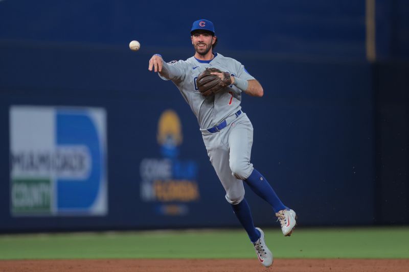 May 19, 2025; Miami, Florida, USA; Chicago Cubs shortstop Dansby Swanson (7) throws to first base to retire Miami Marlins center fielder Derek Hill (not pictured) during the second inning at loanDepot Park. Mandatory Credit: Sam Navarro-Imagn Images