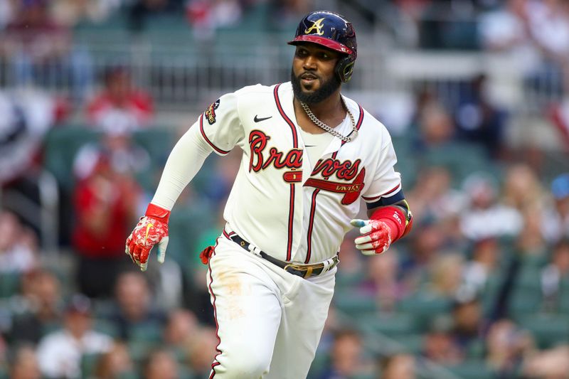 Apr 11, 2022; Atlanta, Georgia, USA; Atlanta Braves left fielder Marcell Ozuna (20) hits a RBI single against the Washington Nationals in the first inning at Truist Park. Mandatory Credit: Brett Davis-USA TODAY Sports