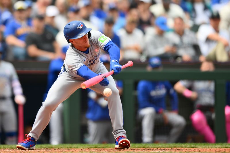 May 11, 2025; Seattle, Washington, USA; Toronto Blue Jays center fielder Myles Straw (3) hits a sacrifice bunt against the Seattle Mariners during the sixth inning at T-Mobile Park. Mandatory Credit: Steven Bisig-Imagn Images