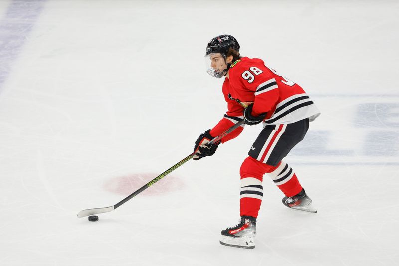 Feb 21, 2024; Chicago, Illinois, USA; Chicago Blackhawks center Connor Bedard (98) looks to pass the puck against the Philadelphia Flyers during the first period at United Center. Mandatory Credit: Kamil Krzaczynski-USA TODAY Sports