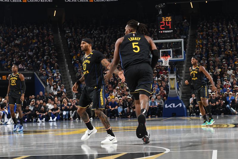 SAN FRANCISCO, CA - NOVEMBER 12: Gary Payton II #0 and Kevon Looney #5 of the Golden State Warriors high five during the game against the Dallas Mavericks during the Emirates NBA Cup game on November 12, 2024 at Chase Center in San Francisco, California. NOTE TO USER: User expressly acknowledges and agrees that, by downloading and or using this photograph, user is consenting to the terms and conditions of Getty Images License Agreement. Mandatory Copyright Notice: Copyright 2024 NBAE (Photo by Noah Graham/NBAE via Getty Images)