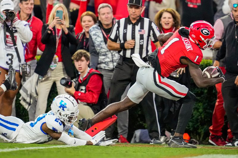 Oct 7, 2023; Athens, Georgia, USA; Georgia Bulldogs wide receiver Marcus Rosemy-Jacksaint (1) runs for a touchdown past Kentucky Wildcats defensive back Andru Phillips (23) during the first quarter at Sanford Stadium. Mandatory Credit: Dale Zanine-USA TODAY Sports