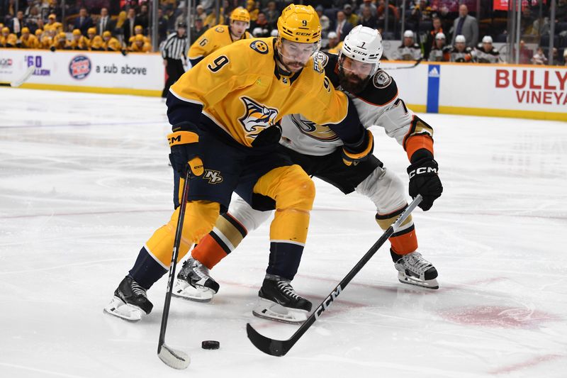 Jan 9, 2024; Nashville, Tennessee, USA; Nashville Predators left wing Filip Forsberg (9) handles the puck against Anaheim Ducks defenseman Radko Gudas (7) during the third period at Bridgestone Arena. Mandatory Credit: Christopher Hanewinckel-USA TODAY Sports