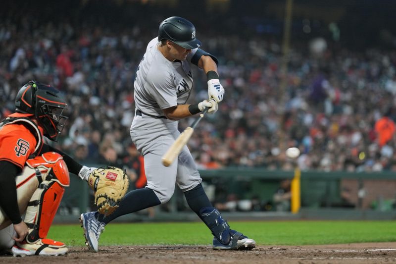 May 31, 2024; San Francisco, California, USA; New York Yankees shortstop Anthony Volpe (center) bats against the San Francisco Giants during the sixth inning at Oracle Park. Mandatory Credit: Darren Yamashita-USA TODAY Sports