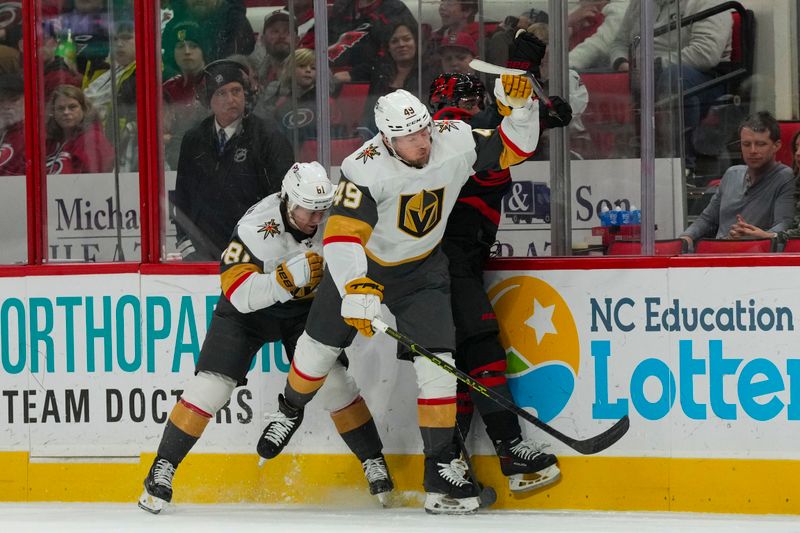 Mar 11, 2023; Raleigh, North Carolina, USA; Vegas Golden Knights center Ivan Barbashev (49) and right wing Jonathan Marchessault (81) checks Carolina Hurricanes center Seth Jarvis (24) during the third period at PNC Arena. Mandatory Credit: James Guillory-USA TODAY Sports