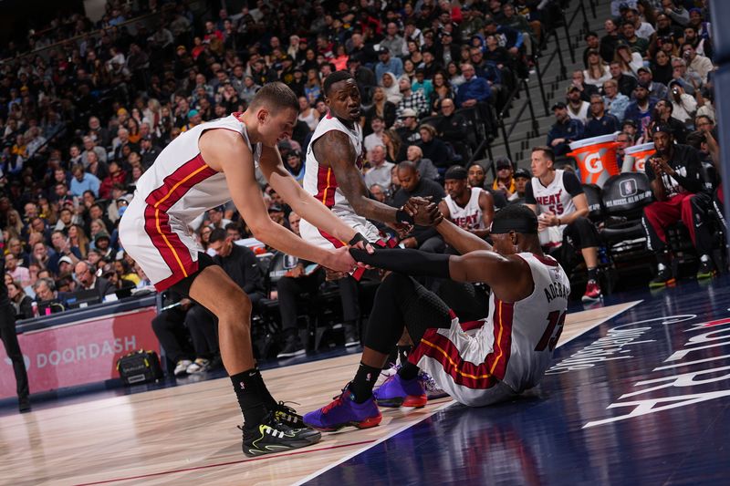 DENVER, CO - FEBRUARY 29: Bam Adebayo #13 of the Miami Heat is helped up by Nikola Jovic #5 and Terry Rozier #2 during the game against the Denver Nuggets on February 29, 2024 at the Ball Arena in Denver, Colorado. NOTE TO USER: User expressly acknowledges and agrees that, by downloading and/or using this Photograph, user is consenting to the terms and conditions of the Getty Images License Agreement. Mandatory Copyright Notice: Copyright 2024 NBAE (Photo by Bart Young/NBAE via Getty Images)