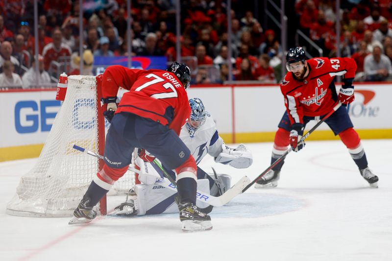 Apr 13, 2024; Washington, District of Columbia, USA; Tampa Bay Lightning goaltender Andrei Vasilevskiy (88) makes a save on Washington Capitals right wing T.J. Oshie (77) as Capitals right wing Tom Wilson (43) looks on in the third period at Capital One Arena. Mandatory Credit: Geoff Burke-USA TODAY Sports