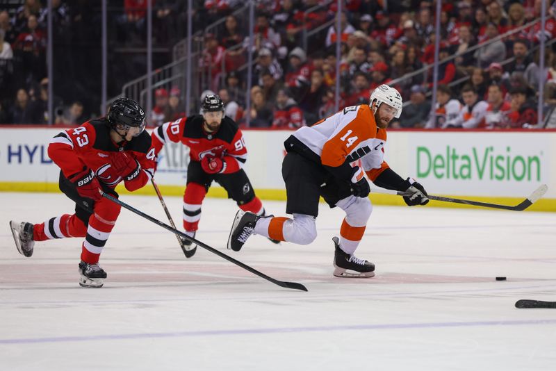 Jan 18, 2025; Newark, New Jersey, USA; Philadelphia Flyers center Sean Couturier (14) skates with the puck while being defended by New Jersey Devils defenseman Luke Hughes (43) during the first period at Prudential Center. Mandatory Credit: Ed Mulholland-Imagn Images